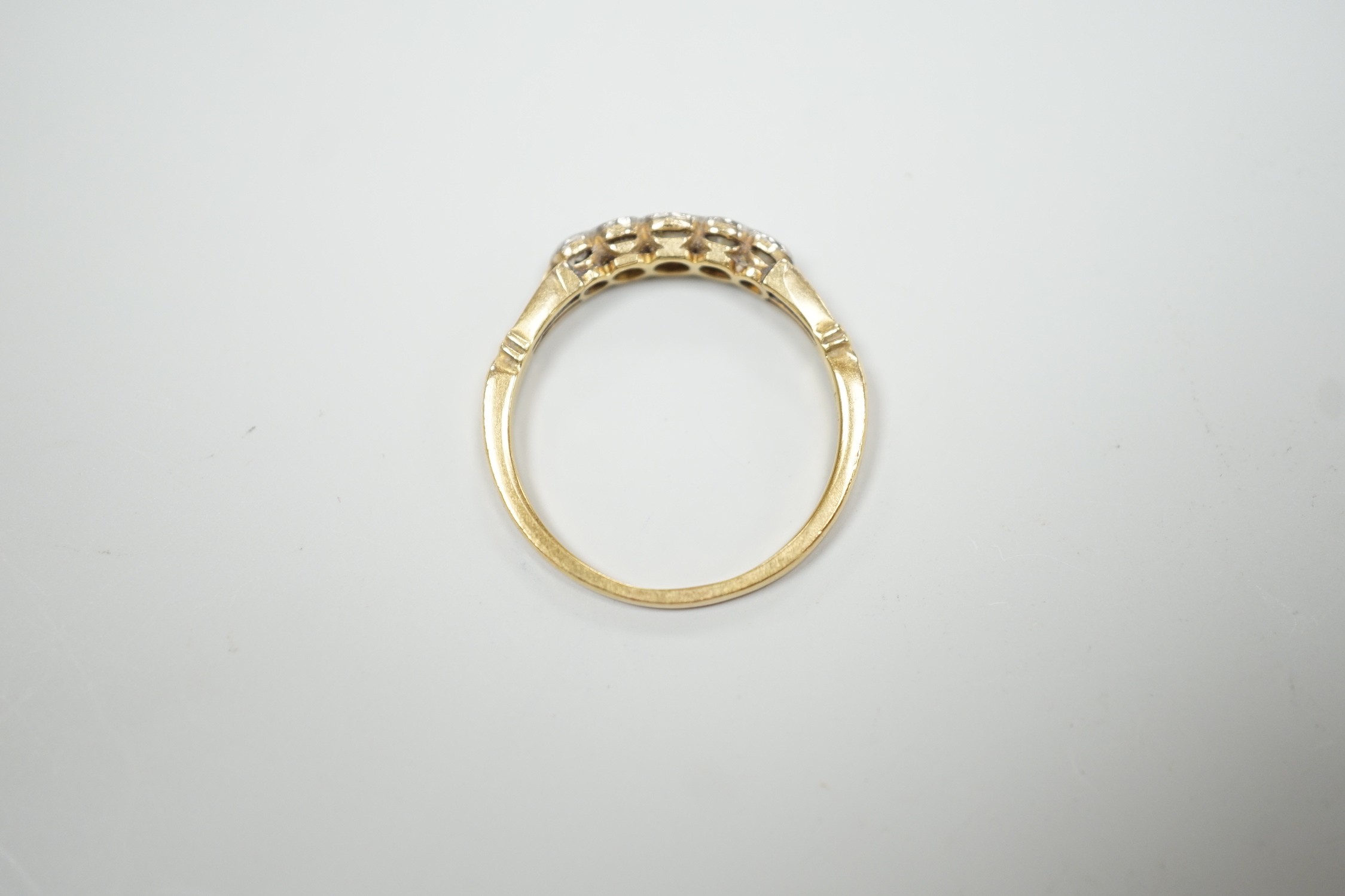 A yellow metal and graduated collet set five stone diamond ring, size N, gross weight 2.2 grams.
